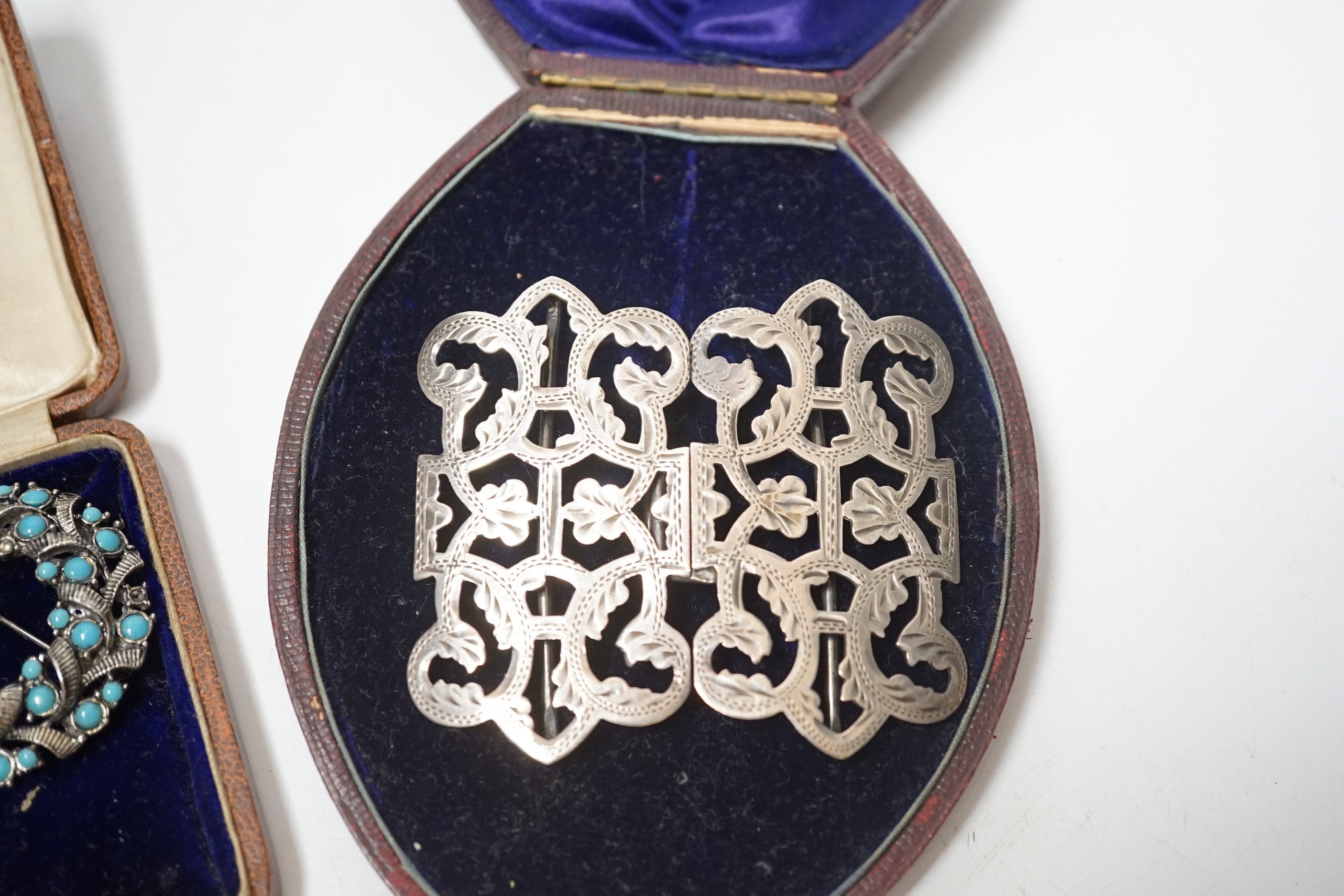 A late Victorian silver belt buckle, Birmingham, 1900, 72mm, three shagreen mounted cigarette holders and two costume brooches.